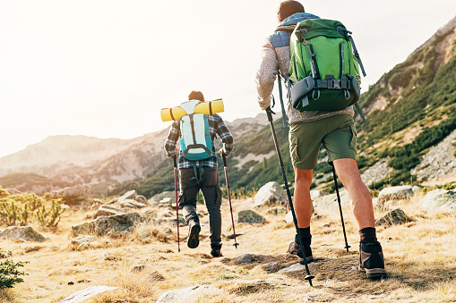 Two backpackers climbing a mountain
