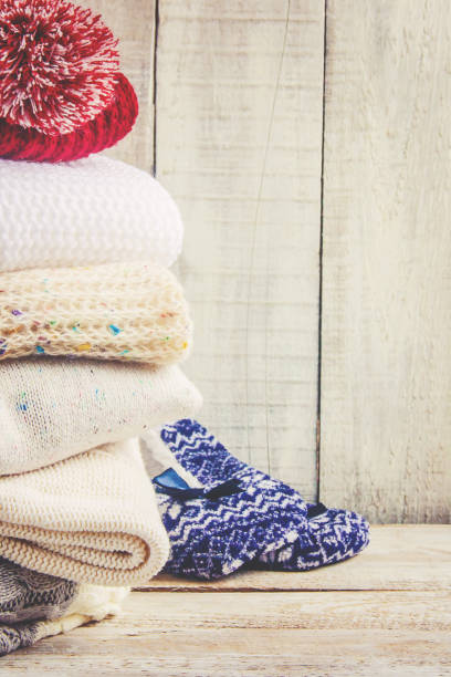 istock Warm Winter Clothes on a wooden background. Selective focus. 1067471584