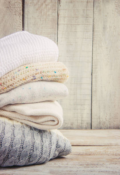istock Warm Winter Clothes on a wooden background. Selective focus. 1067471602