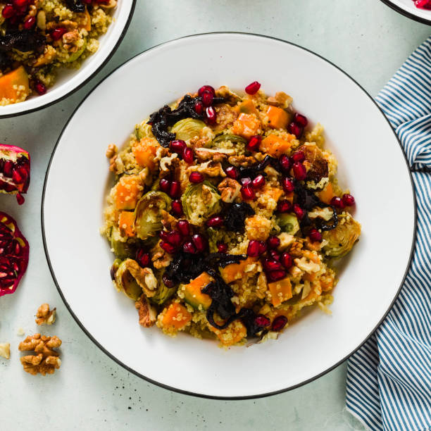 istock Delicious autumn festive salad of pumpkin, brussels sprouts, quinoa, walnuts, caramelized onions and pomegranate seeds. Healthy Vegan Gourmet Recipe 1067477708