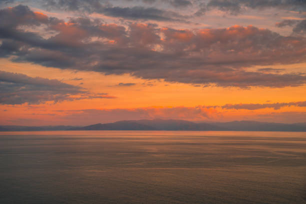 istock Colorful sunset with dramatic sky background over sea. 1067479144
