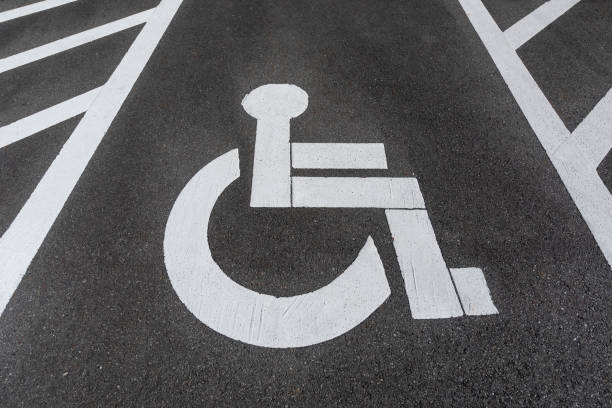 istock handicapped / disabled parking sign painted on the road asphalt. 1067482992
