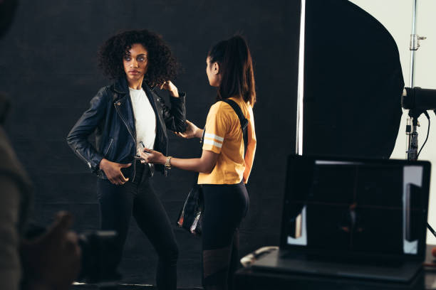 istock Stylist adjusting model during a fashion shoot 1067485634
