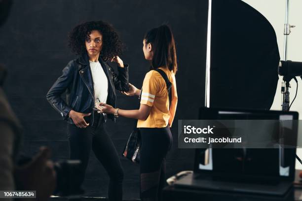 Stylist adjusting model during a fashion shoot