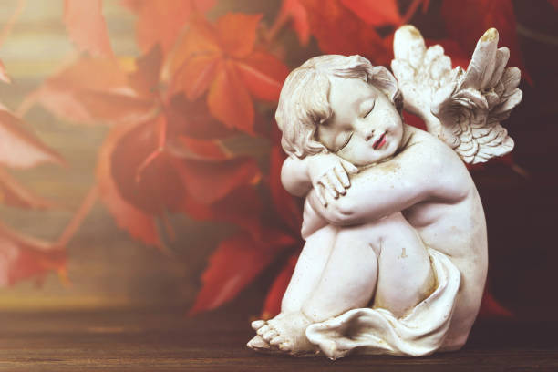 istock Guardian angel and red autumn leaves 1067485800