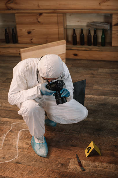 istock forensic investigator documenting evidence with camera at crime scene 1067487540