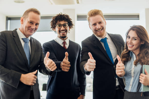 istock Coworkers pointing thumbs up 1067491394