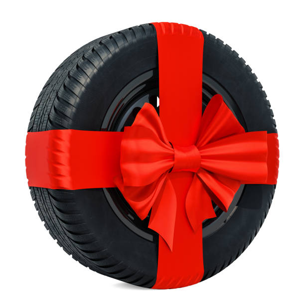 istock Car wheel wrapped ribbon and bow, gift concept. 3D rendering isolated on white background 1067491658
