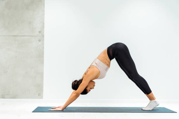 istock Relaxed girl practicing hatha yoga in yoga studio 1067497618
