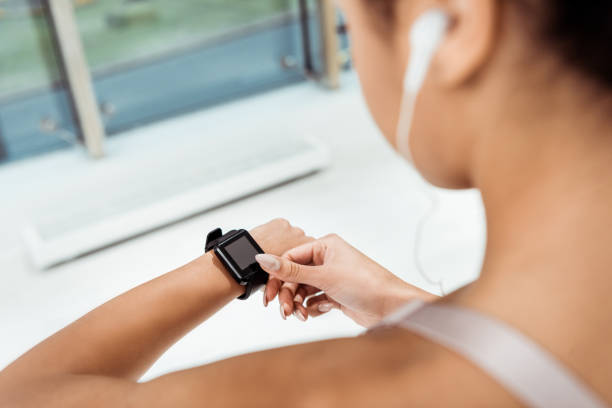 istock Partial view of girl using fitness tracker 1067497790