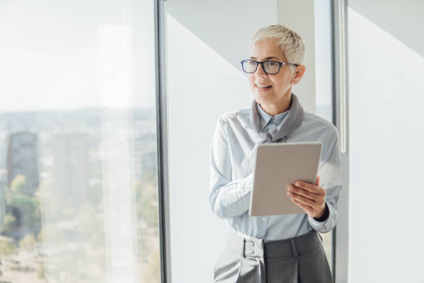istock Happy business woman with digital tablet 1067499524