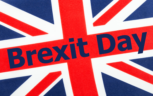 Brexit Day written on a British Union jack flag. Photograph with added text.