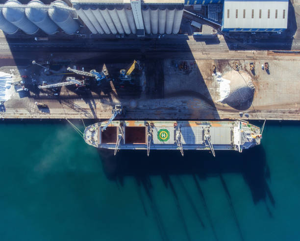 Top view of a bulker with an open empty hold. Aerial view to unload the cargo ship stock photo