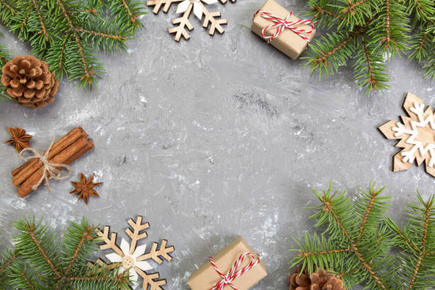 istock Christmas background with fir tree and gift box on wooden table. Top view with copy space for your design 1067501848
