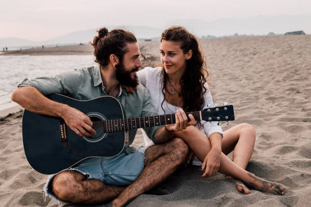 istock Man playing guitar for his girlfriend 1067505978