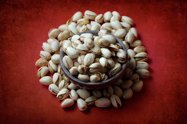 Bowl with pistachio on wooden table