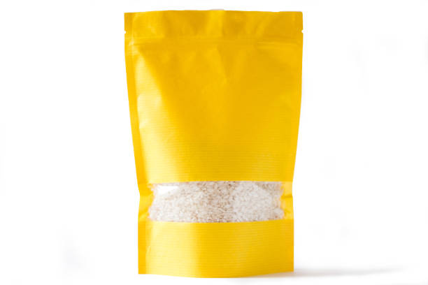 yellow paper doypack stand up bio pouch with window  zipper on white background filled with rice stock photo