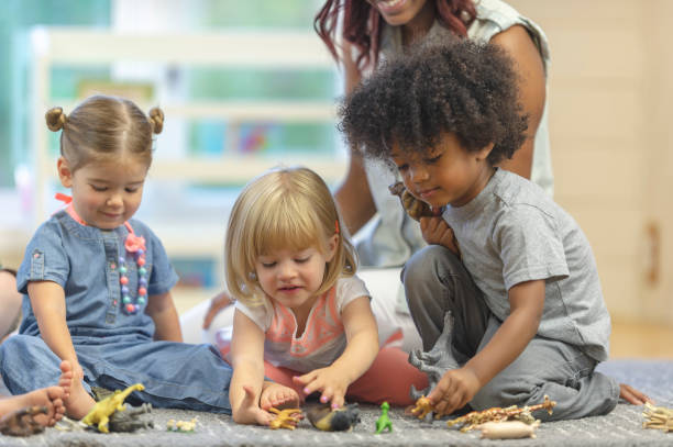 istock Preschoolers playing with animal figurines 1067510816