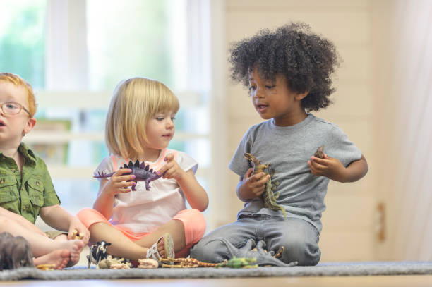 istock Preschoolers play with dinosaurs 1067510818