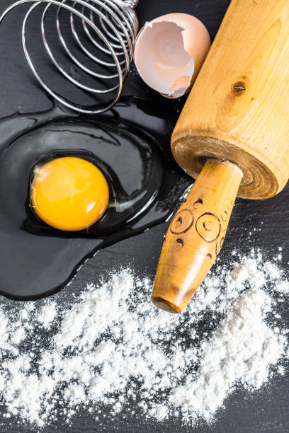 istock Preparing dough. Cooking concept. Ingredients for baking - flour, egg, rolling pin, egg beater and wooden spoon. 1067515486