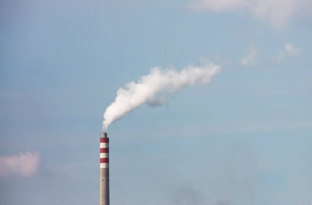 istock Industrial building with one chimney background on blue sky 1067518370