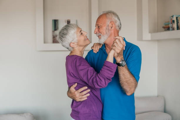 Older couple dancing Senior couple in love dancing at home middle aged couple dancing stock pictures, royalty-free photos & images