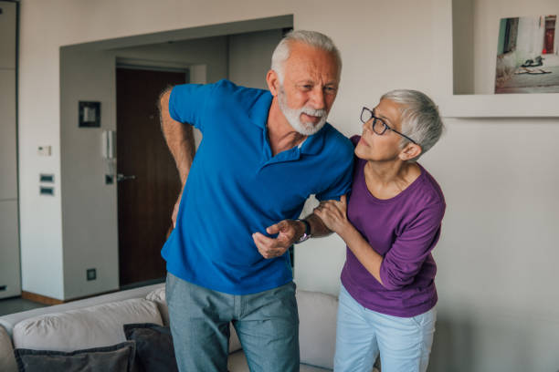 istock Concerned woman helping husband with backache 1067519956
