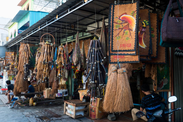 Souvenirs at Hamadi market in Jayapura, Papua, Indonesia A variety of souvenirs, including tapa cloths, penis gourds, and bilums, hang outside shops at the Hamadi market in Jayapura, Papua, Indonesia (July 2017) koteka stock pictures, royalty-free photos & images