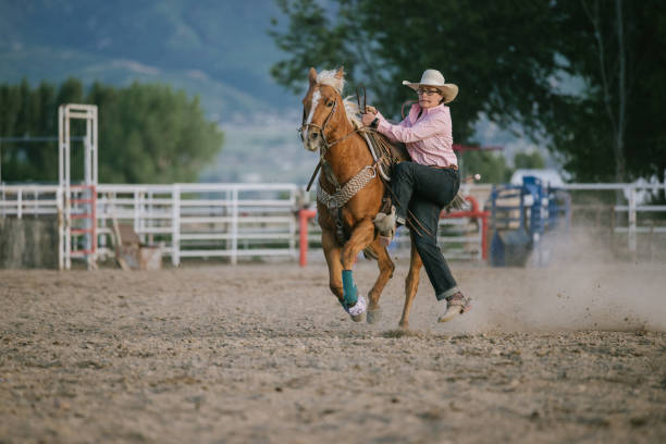 istock Cowboys lassoing calf on ranch 1067534504