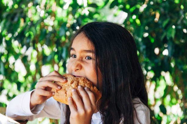 Little girl enjoying a burger