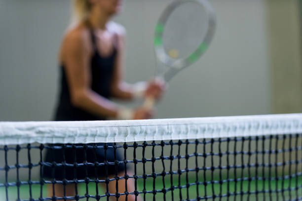 istock Woman Playing Tennis 1067543388