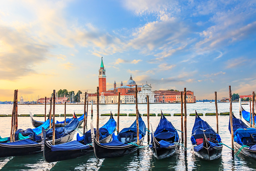 Gondolas moored at the pier in Grand Canal with San Giorgio Maggiore in the background, Venice, Italy