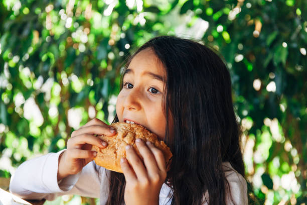 Little girl enjoying a burger