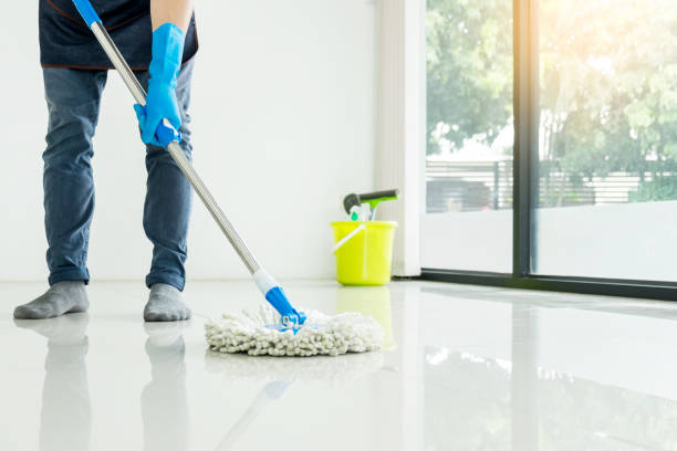 istock Low Section Man Cleaning Floor With Mop At Home 1067546904