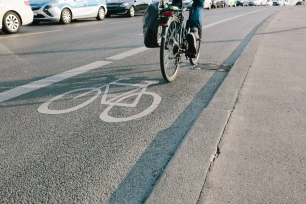 istock Low Section Of Man Riding Bicycle On Road 1067546916