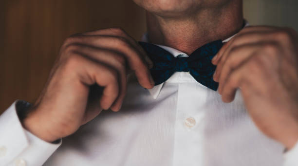 istock Midsection Of Man Touching Bow Tie 1067546920