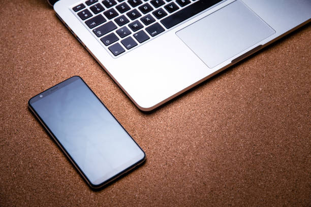 istock High Angle View Of Mobile Phone By Laptop On Table 1067551228