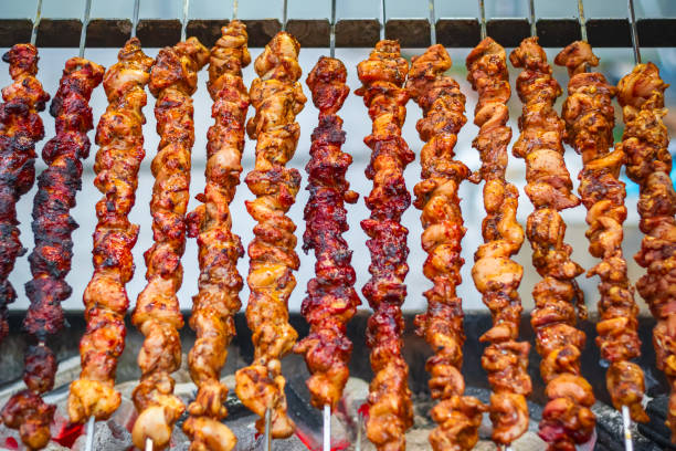 istock Chicken kebabs cooking on a charcoal grill 1067555220