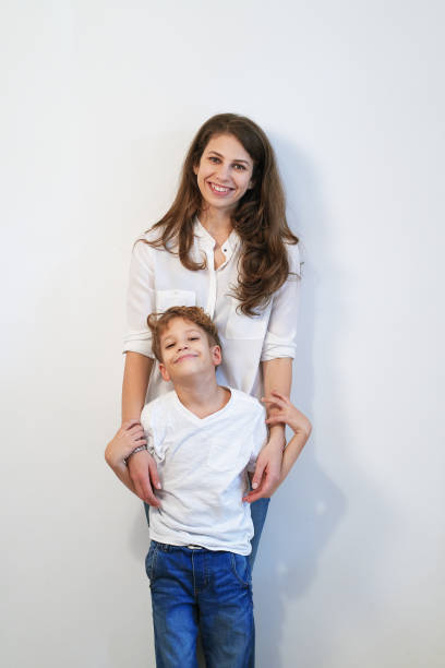 istock Mother and preteen son posing on white background 1067555514