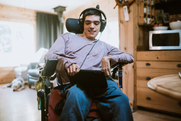 confident young man in wheelchair at home - motorized wheelchair audio imagens e fotografias de stock