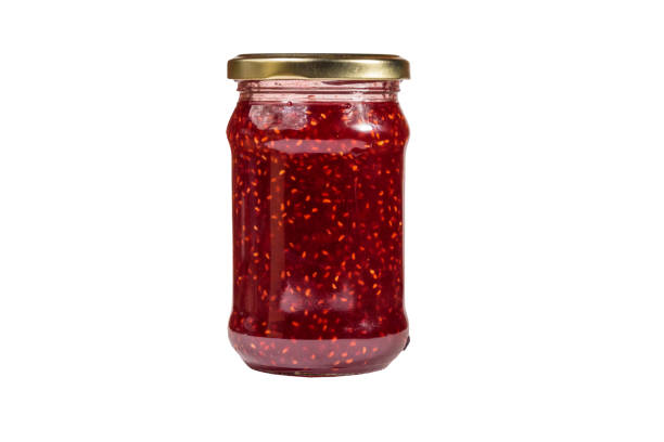 istock Raspberry jam in glass jar isolated on white background 1067573168