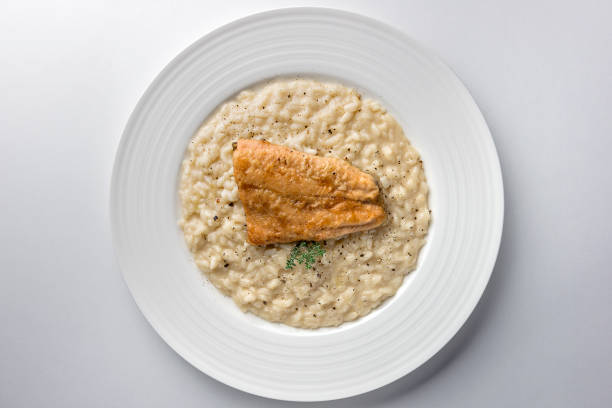 Italian risotto with asparagus. Creamy asparagus risotto on wooden background.