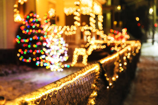 shiny Christmas decorations outside at night blurred background city street with Christmas illuminations. Cope space for your text christmas lights house stock pictures, royalty-free photos & images