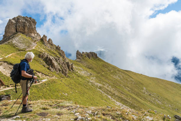 istock Senior men trekking under Violet peaks of Dolomites 1067575442