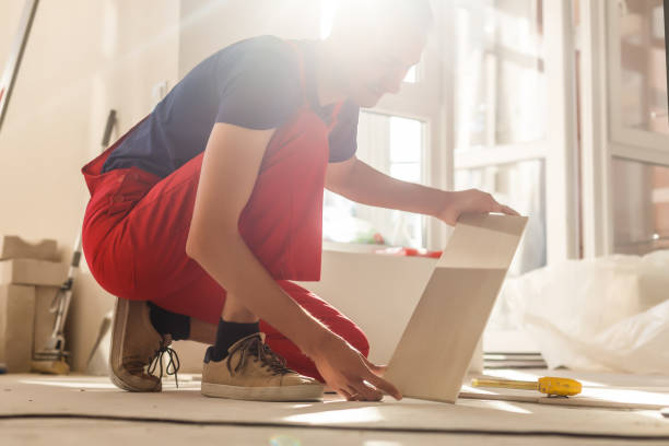 istock Home improvement, renovation - construction worker tiler is tiling, ceramic tile floor adhesive 1067581566