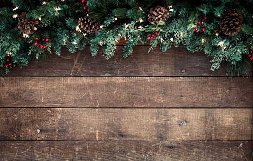 Christmas garland on an old wood background with copy space