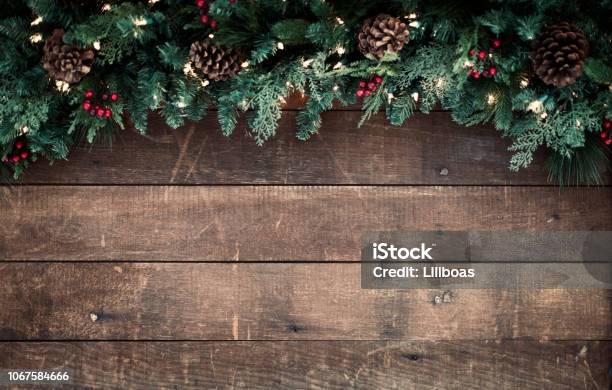 Christmas Garland On An Old Wood Background Stock Photo - Download Image Now - Christmas, Backgrounds, Table