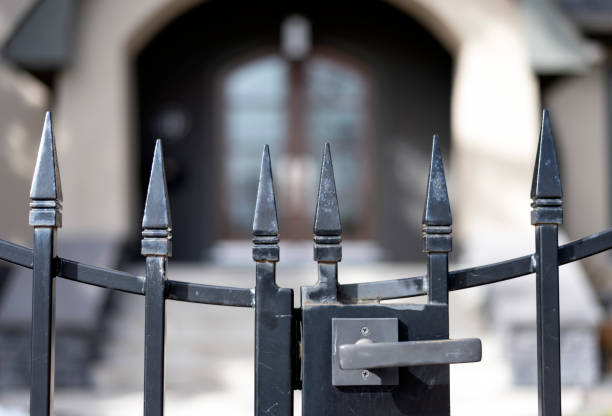 istock Black iron fence in front of house 1067587004