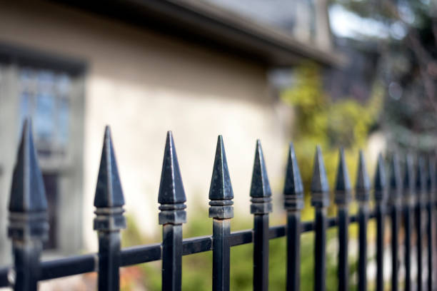 istock Black iron fence by building 1067590304