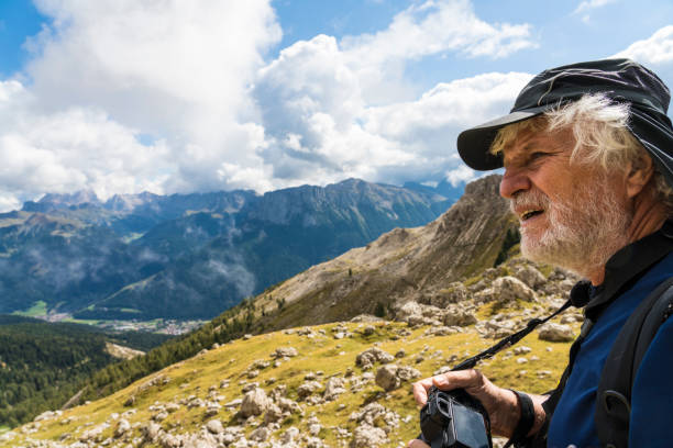 istock Senior men trekking under Violet peaks of Dolomites 1067593308